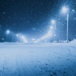 Captivating winter scene of a snowy street in Vitebsk, Belarus, with glowing streetlights.