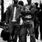 Black and white photo of two men showcasing urban street fashion in downtown Atlanta.