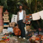 Explore colorful African crafts and textiles at an outdoor market in Abuja, Nigeria.